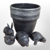 Four painted metal garden ornaments and a set of eight plastic pots.