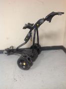 A Powakaddy electric golf bag caddy, together with a barbell.