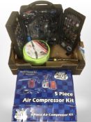 A group of tools and hardware including air compressor, air hose, cased multi-tool set, etc.