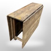 A 19th-century pine drop-leaf dining table, extended 172cm long x 104cm wide x 77cm high.