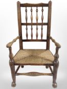 A 19th-century child's oak armchair with rattan seat, together with a circular stool.