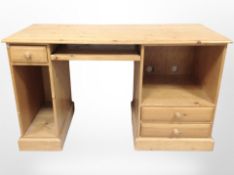 A contemporary pine desk/dressing table, 130cm wide x 58cm deep x 76cm high.