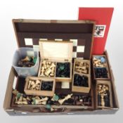 A collection of turned wooden chess sets and chessboards.