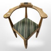 A continental oak corner armchair bearing the carved initials 'C C'.