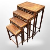An early-20th century Chinese carved hardwood nest of four tables, width 47cm.