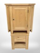 A contemporary oak corner cabinet, height 79cm,