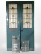A pair of early 20th-century painted doors with stained and leaded glass panels,