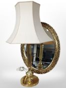 A reproduction gilt oval mirror, length 71cm, together with a brass table lamp.