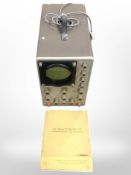 A Heathkit oscilloscope with manual and plug.