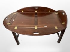 A mahogany butler's tray table, length 138cm extended.