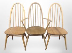 A pair of Ercol elm and beech spindle back dining chairs and a similar carver armchair.