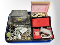 A group of boxes and tins containing assorted costume jewellery, bead necklaces, bangles, etc.