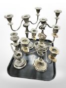 A group of silver-plated table candelabra.