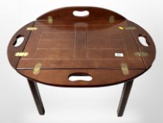 A mahogany butler's tray table, length 77cm extended.