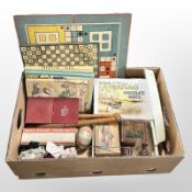 A group of vintage boxes, juggling batons, children's volumes, board game boards, etc.