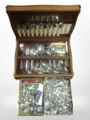 An oak canteen of stainless steel cutlery and a large quantity of collector's spoons.