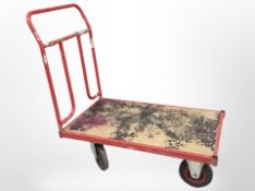 A flat bed goods trolley, length 125cm.