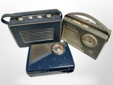 A Hacker Herald portable radio, a further Rema radio, and a transistor radio.