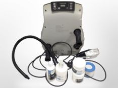 A Waves spa pump with box of spa filter and chemicals.