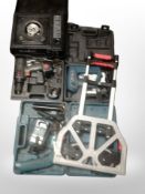 A group of boxed power tools including staple gun, Makita drill, etc.