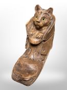 A treen inkwell in the form of a cat sat in a boot, length 14cm.