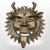 A Tibetan gilt bronze temple mask, diameter 21cm.