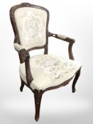 A continental carved salon armchair in tapestry fabric, width 62cm.