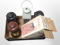 A Tilley storm light, in box, and three further oil lamps and a modern lantern.