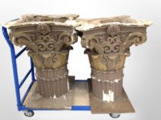 A pair of ornate painted and parcel gilt Corinithian-style column terminals, on plywood bases,
