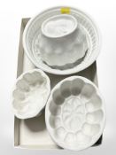 Four cream ware jelly moulds.
