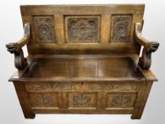 A 19th-century and later carved oak monk's bench, 125cm wide x 51cm deep x 102cm deep.