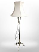 An ornate brass and polished onyx standard lamp.