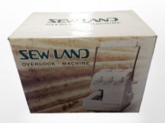 A Sew Land overlock machine, in box.