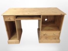 A contemporary pine desk/dressing table, 130cm wide x 58cm deep x 76cm high.