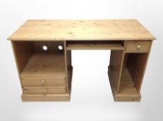 A contemporary pine desk/dressing table, 130cm wide x 58cm deep x 76cm high.