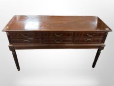A reproduction mahogany six-drawer sideboard on reeded legs, 122cm wide x 42cm deep x 72cm high.