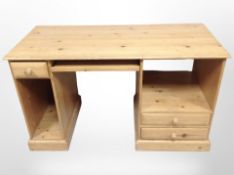 A contemporary pine desk/dressing table, 130cm wide x 58cm deep x 76cm high.