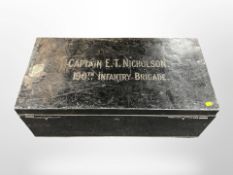 A lacquered tin military trunk with stencilled writing, Cpt.