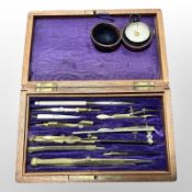 A mahogany-cased precision drawing instrument set, together with a damp detector in travel case.