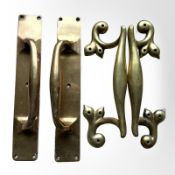 Two pairs of early-20th century brass door handle pulls, length 30cm.
