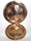 Two hammered copper chargers, largest 54cm.