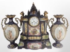 A late-Victorian transfer-printed ceramic three-piece clock garniture, height 52cm.