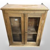 A 19th-century glazed oak wall cabinet, 67cm wide x 28cm deep x 81cm high.