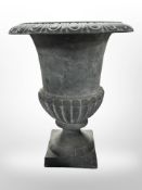 A cast-iron campana urn, height 30cm.