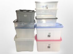 Nine plastic storage boxes with lids.
