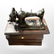 An antique cast-iron Federation hand sewing machine, in box.