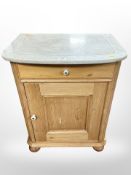 A 19th-century pine and white marble-topped wash stand, 63cm wide x 44cm deep x 81cm high.