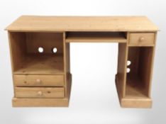 A contemporary pine desk/dressing table, 130cm wide x 58cm deep x 76cm high.