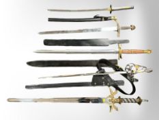 Five fantasy swords including katana, basket-hilted sword, etc., four in scabbards.