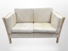 A 20th-century cream suede two-seater settee, width 138cm.